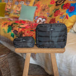 SCOUT Tiny Treasures zip pouch shown in a compact size with a solid black durable fabric, styled as a small travel and cosmetic organizer for makeup and accessories