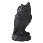 Black owl statue on a white background