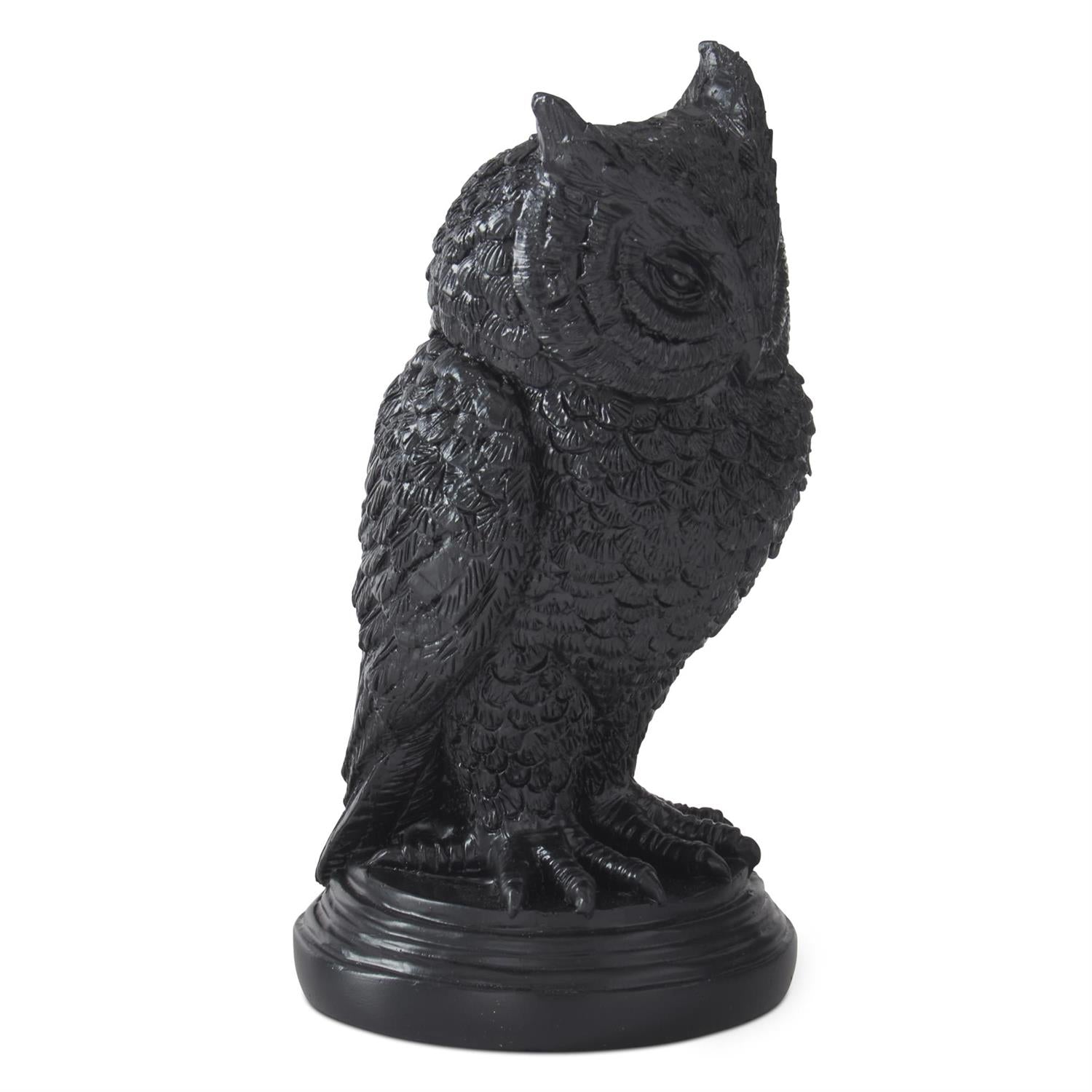 Black owl statue on a white background