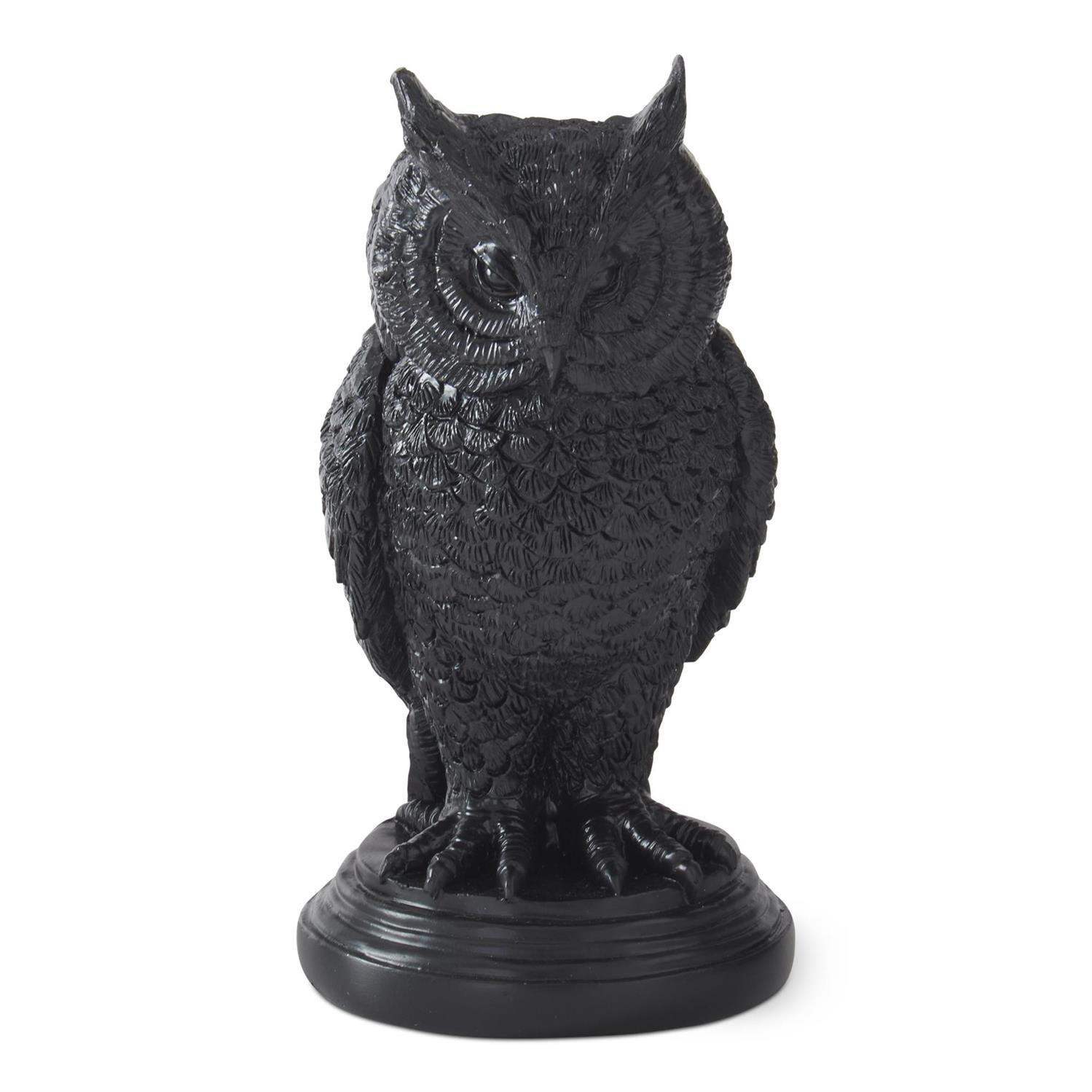 Black owl statue on a white background