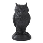 Black owl statue on a white background