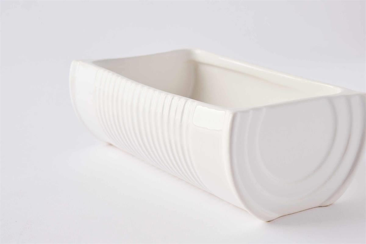 White ceramic bowl with textured surface on a light gray background