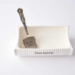 Ceramiic white dish for cranberry sauce Decorative knife with 'Slice Serve' tag on a white surface