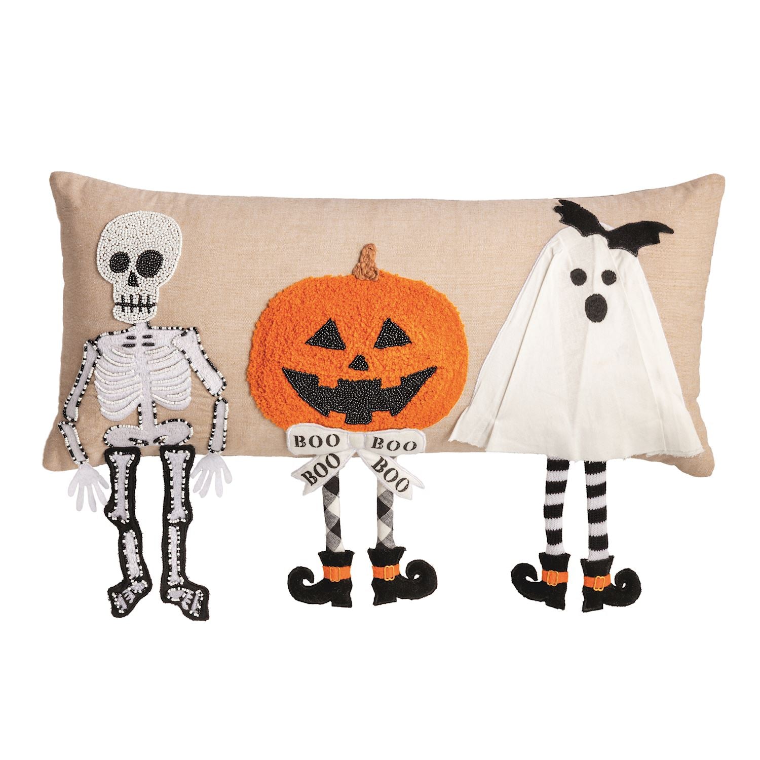 A rectangular beige throw pillow featuring embroidered Halloween characters: a white skeleton on the left, an orange pumpkin in the center holding a 'BOO BOO' banner, and a white ghost on the right with black witch shoes.