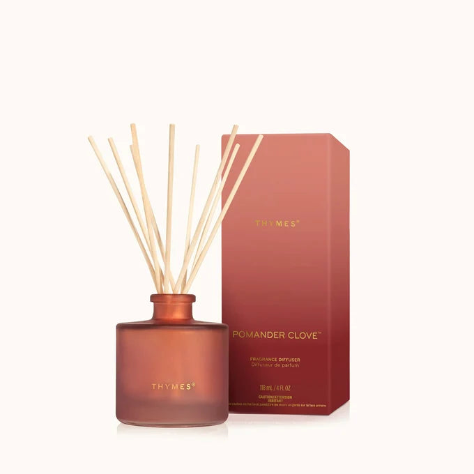Thymes pomander clove diffuser with reeds and packaging on a white background