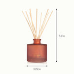 A reed diffuser bottle in frosted amber-brown glass with light natural reeds, shown on a white background with dimension markers indicating 7.5 in height and 3.