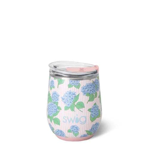 Swig Hydrangeas Stemless Wine Cup 12oz featuring soft blue hydrangea clusters on a blush and white pinstripe background with EZ Slider lid
