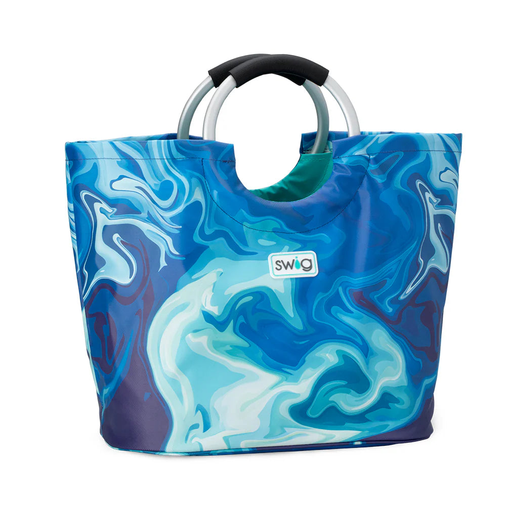 Swig Blue Lagoon Loopi Tote Bag featuring swirling aqua and navy blue pattern with cushioned aluminum loop handles