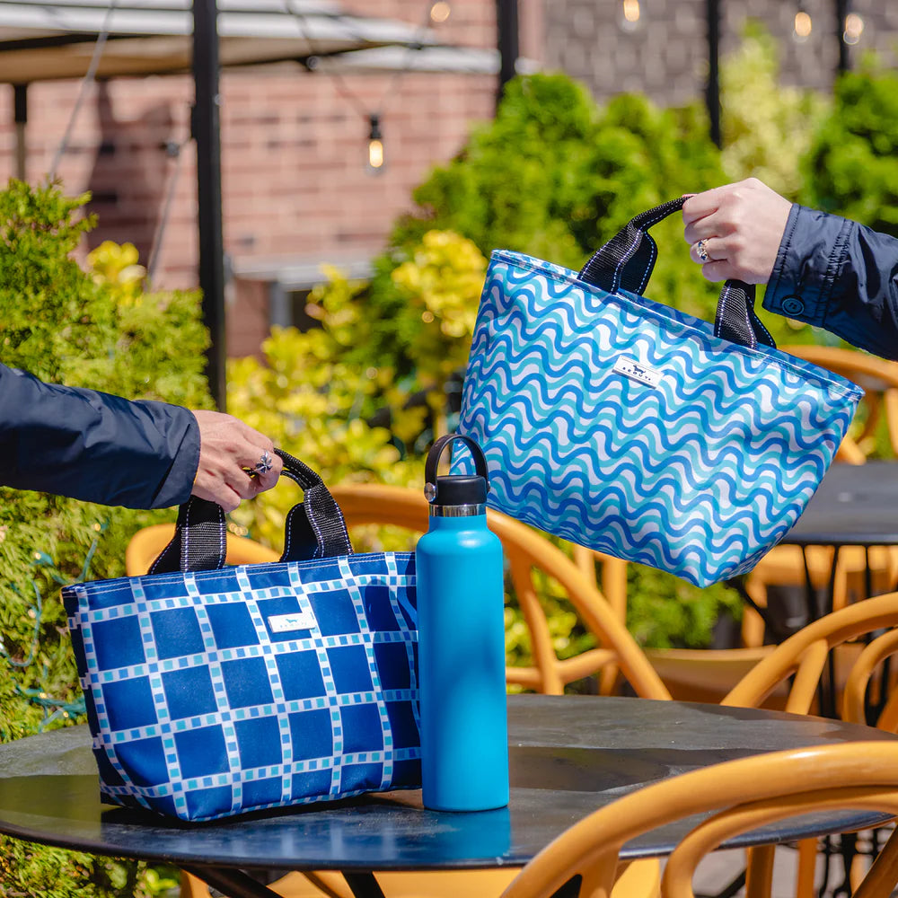 SCOUT Nooner Lunch Bag insulated lunch tote shown in a structured rectangular design with top handle and zip closure, styled as a compact everyday food carrier