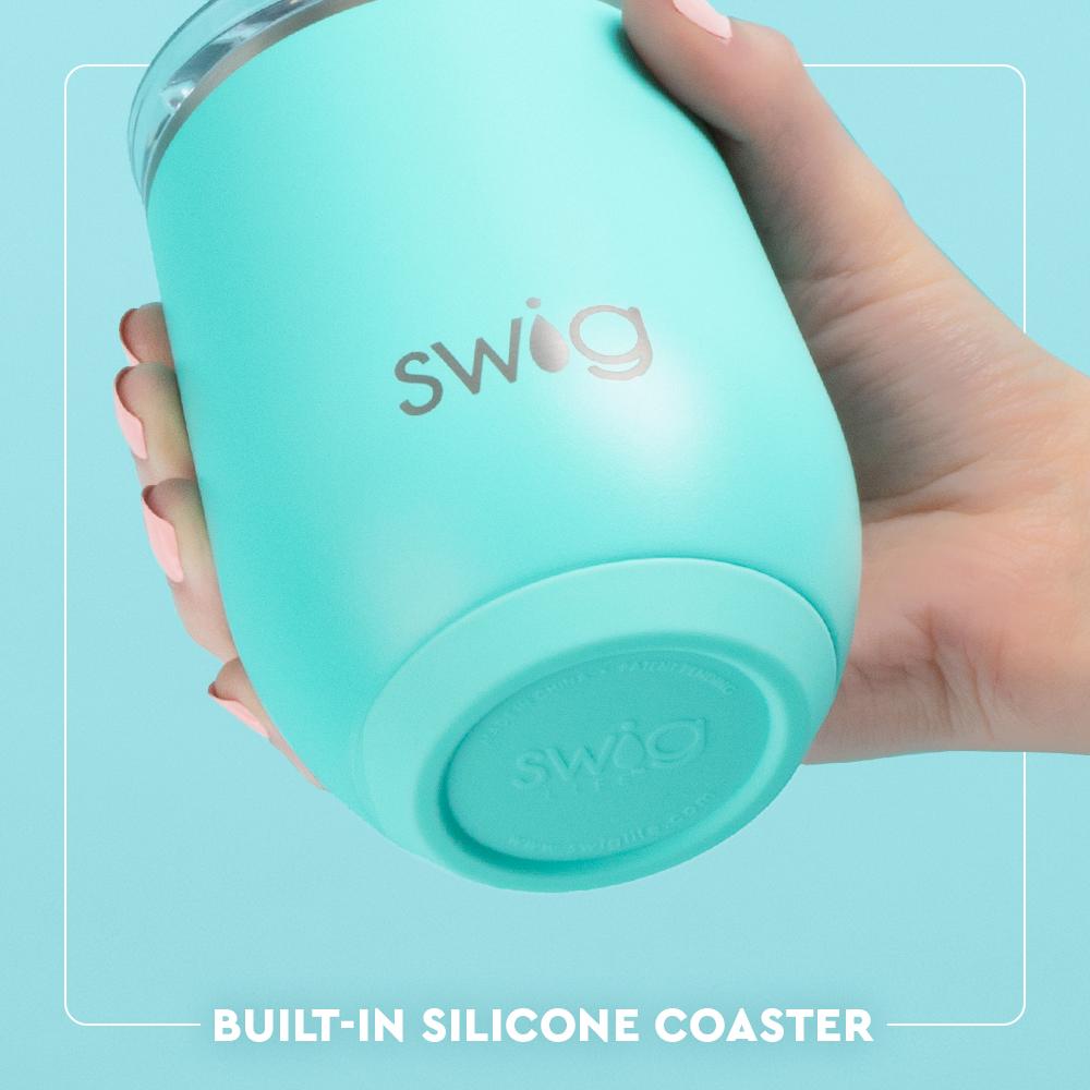Turquoise Swig tumbler held by a hand with a light blue background