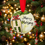 Christmas ornament with 'Merry Mahjong' text and decorative elements on a wooden surface.